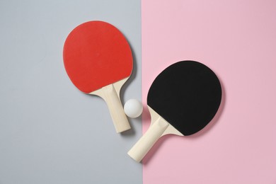 Photo of Ping pong rackets and ball on color background, flat lay