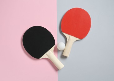 Photo of Ping pong rackets and ball on color background, flat lay