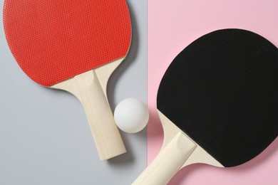 Photo of Ping pong rackets and ball on color background, flat lay