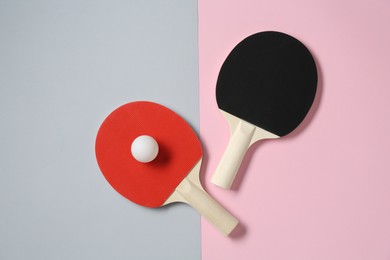 Photo of Ping pong rackets and ball on color background, flat lay