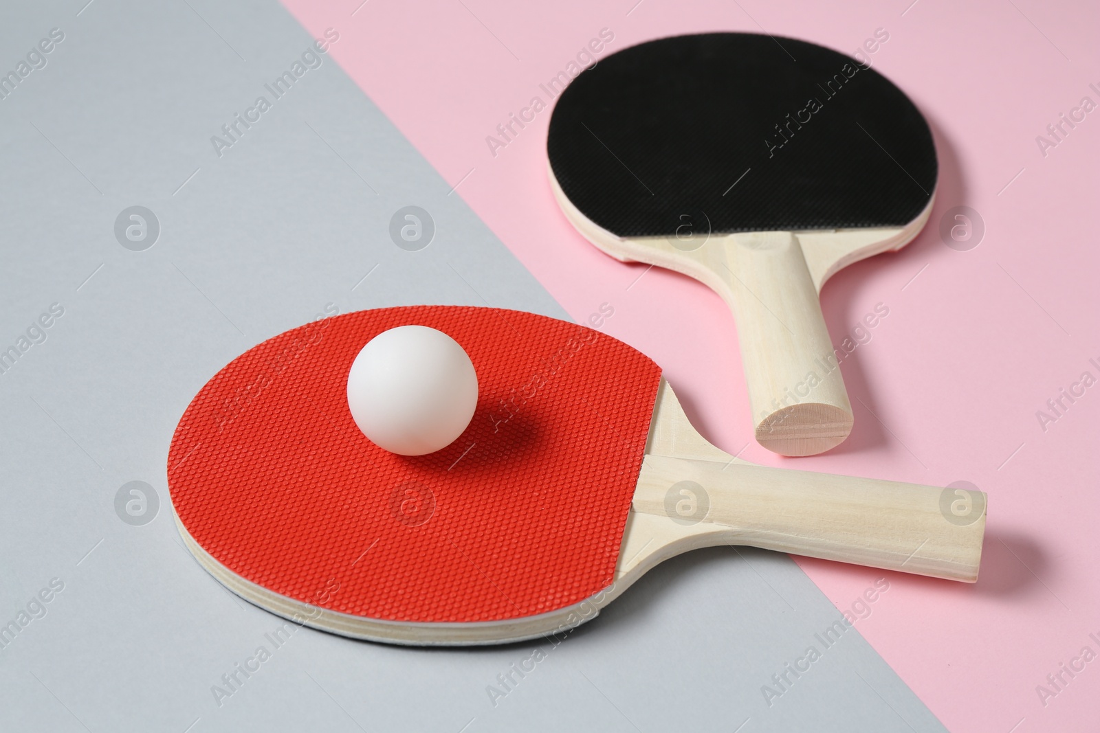 Ping pong rackets and ball on color background, closeup Photo of Ping pong rackets and ball on color background, closeup