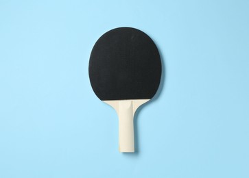 Photo of Ping pong racket on light blue background, top view