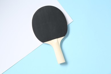 Photo of One ping pong racket on color background, top view