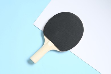 Photo of One ping pong racket on color background, top view