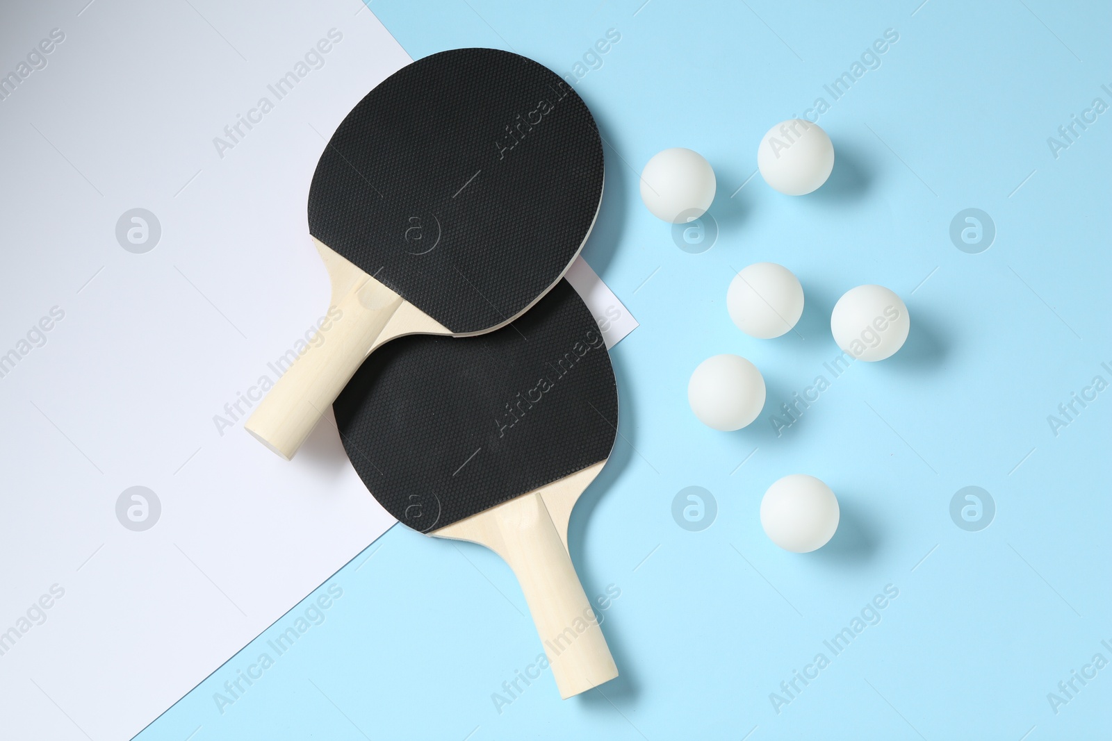 Ping pong rackets and balls on color background, flat lay Photo of Ping pong rackets and balls on color background, flat lay