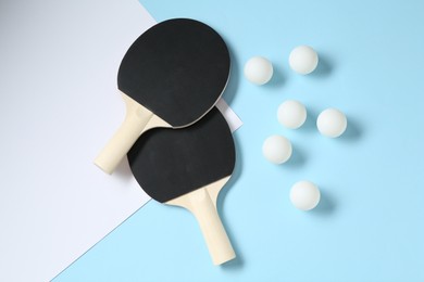 Photo of Ping pong rackets and balls on color background, flat lay