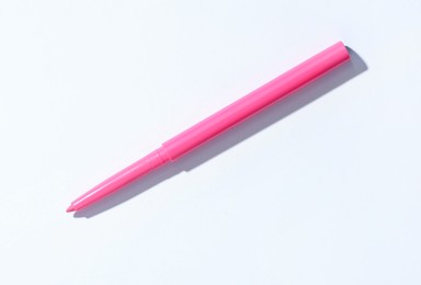 Photo of One twist up eye pencil on white background, top view