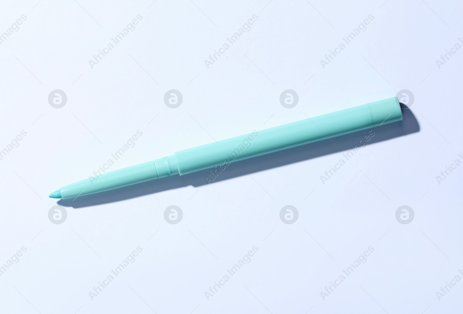One twist up eye pencil on white background, top view Photo of One twist up eye pencil on white background, top view