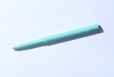 Photo of One twist up eye pencil on white background, top view