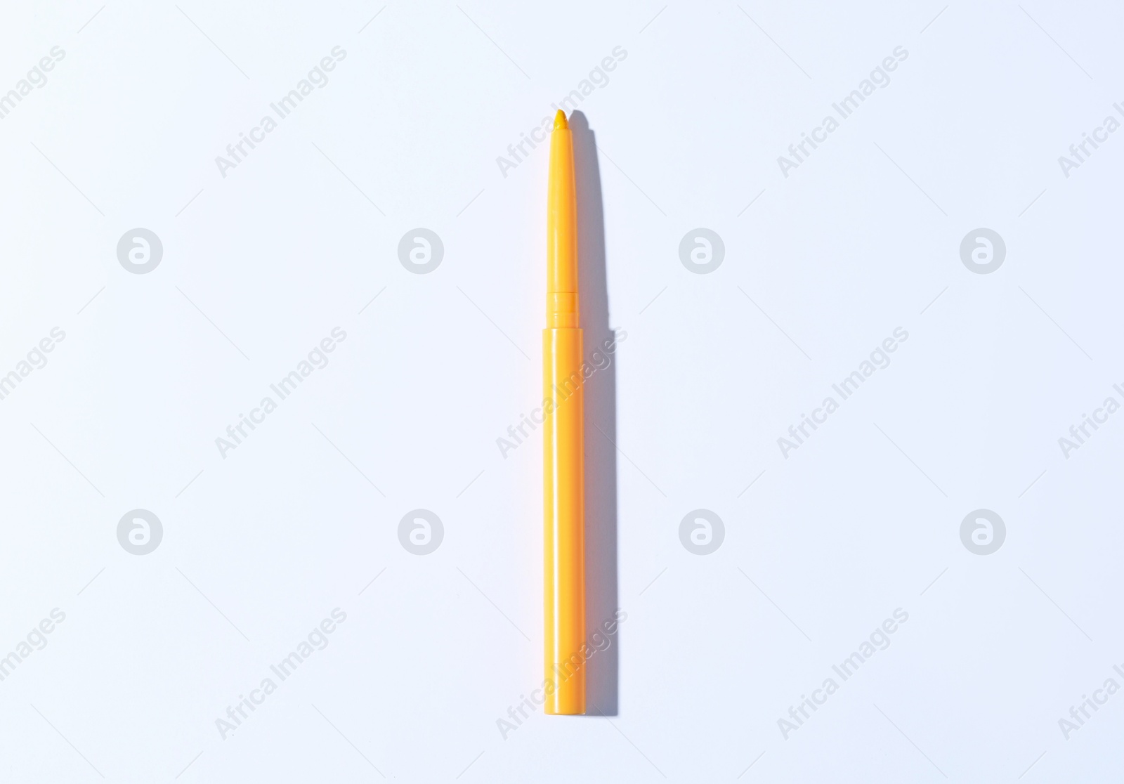 One twist up eye pencil on white background, top view Photo of One twist up eye pencil on white background, top view