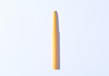 Photo of One twist up eye pencil on white background, top view