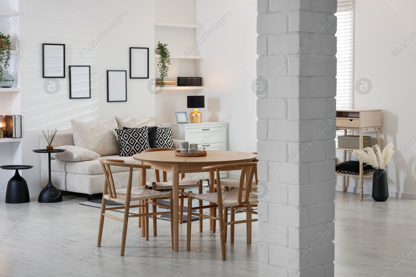 Table, chairs and comfortable sofa indoors. Interior design Photo of Table, chairs and comfortable sofa indoors. Interior design