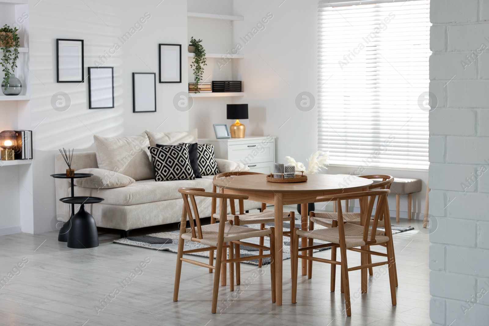 Table, chairs and comfortable sofa indoors. Interior design Photo of Table, chairs and comfortable sofa indoors. Interior design