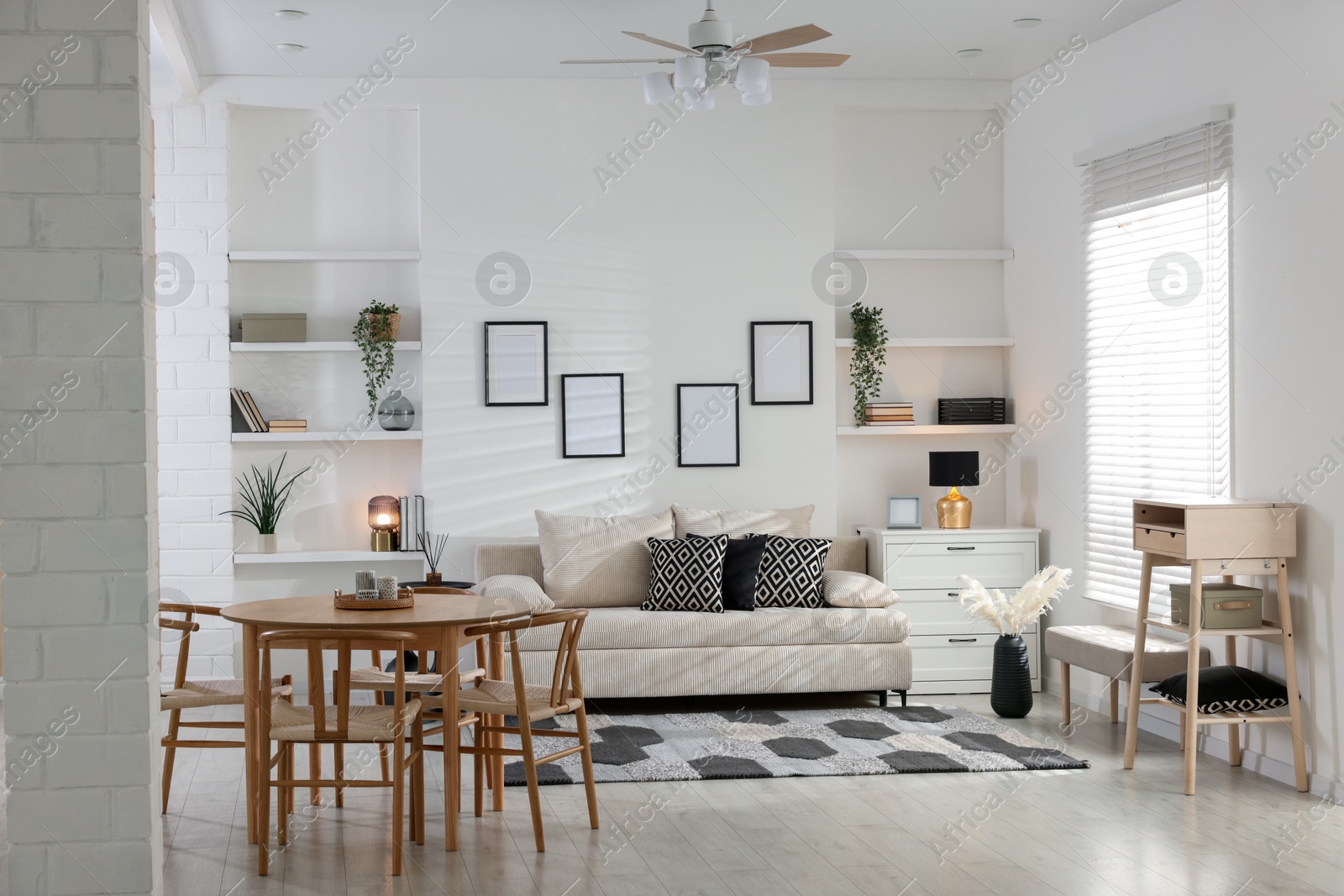 Comfortable sofa, table, chairs and dresser indoors. Interior design Photo of Comfortable sofa, table, chairs and dresser indoors. Interior design