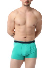 Photo of Young man in stylish turquoise underwear on white background, closeup