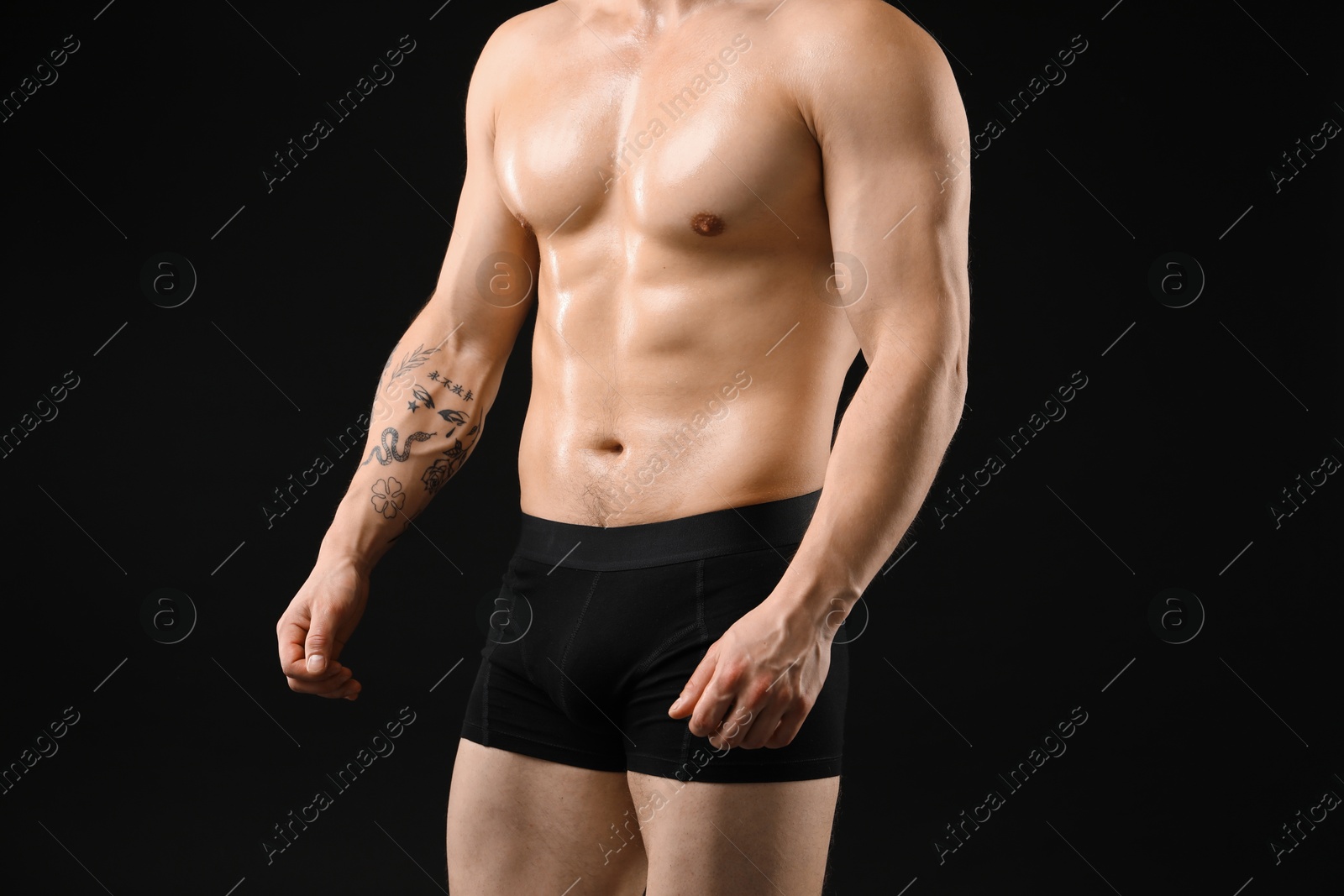 Young man in stylish underwear on black background, closeup Photo of Young man in stylish underwear on black background, closeup