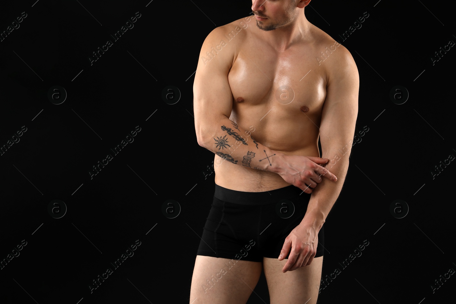 Young man in stylish underwear on black background, closeup. Space for text Photo of Young man in stylish underwear on black background, closeup. Space for text