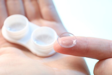 Photo of Woman with contact lenses on light background, closeup