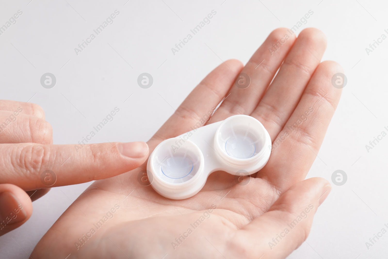 Woman with contact lenses on light background, closeup Photo of Woman with contact lenses on light background, closeup