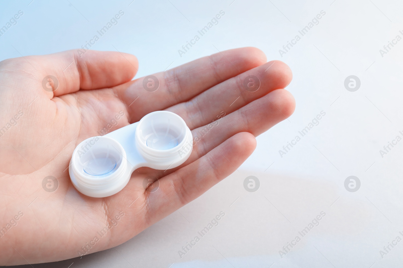 Woman with contact lenses on light background, closeup Photo of Woman with contact lenses on light background, closeup