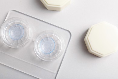 Photo of Case with contact lenses on white background, flat lay