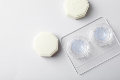 Photo of Case with contact lenses on white background, flat lay. Space for text
