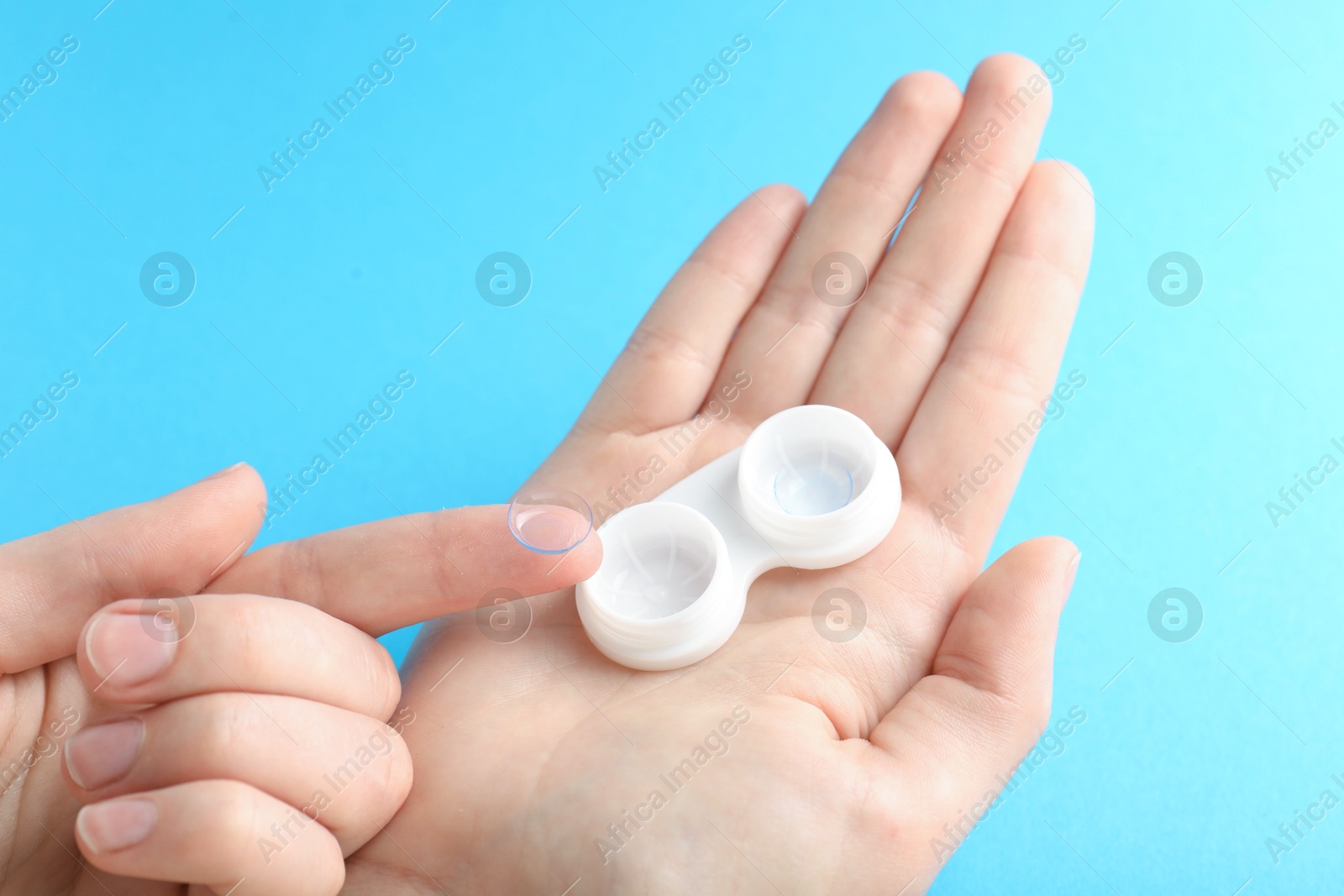 Woman with contact lenses on light blue background, closeup Photo of Woman with contact lenses on light blue background, closeup