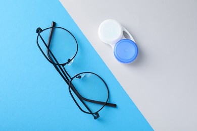 Photo of Case with contact lenses and glasses on color background, flat lay