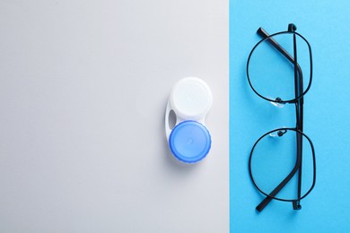 Photo of Case with contact lenses and glasses on color background, flat lay. Space for text