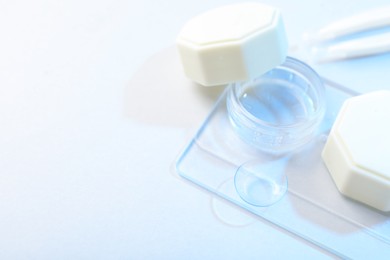 Photo of Case with contact lenses on white background, closeup. Space for text