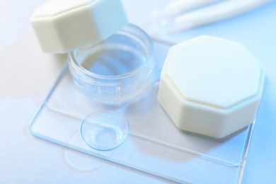 Photo of Case with contact lenses on white background, closeup