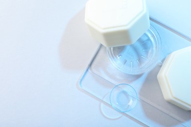 Photo of Case with contact lenses on white background, top view. Space for text
