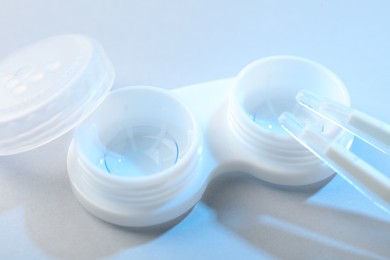 Photo of Case with contact lenses on white background, closeup
