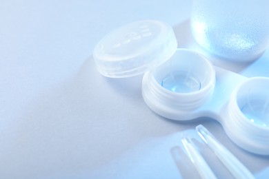 Photo of Case with contact lenses on white background, closeup. Space for text