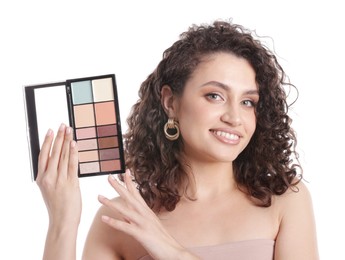 Photo of Smiling woman with eyeshadow palette on white background