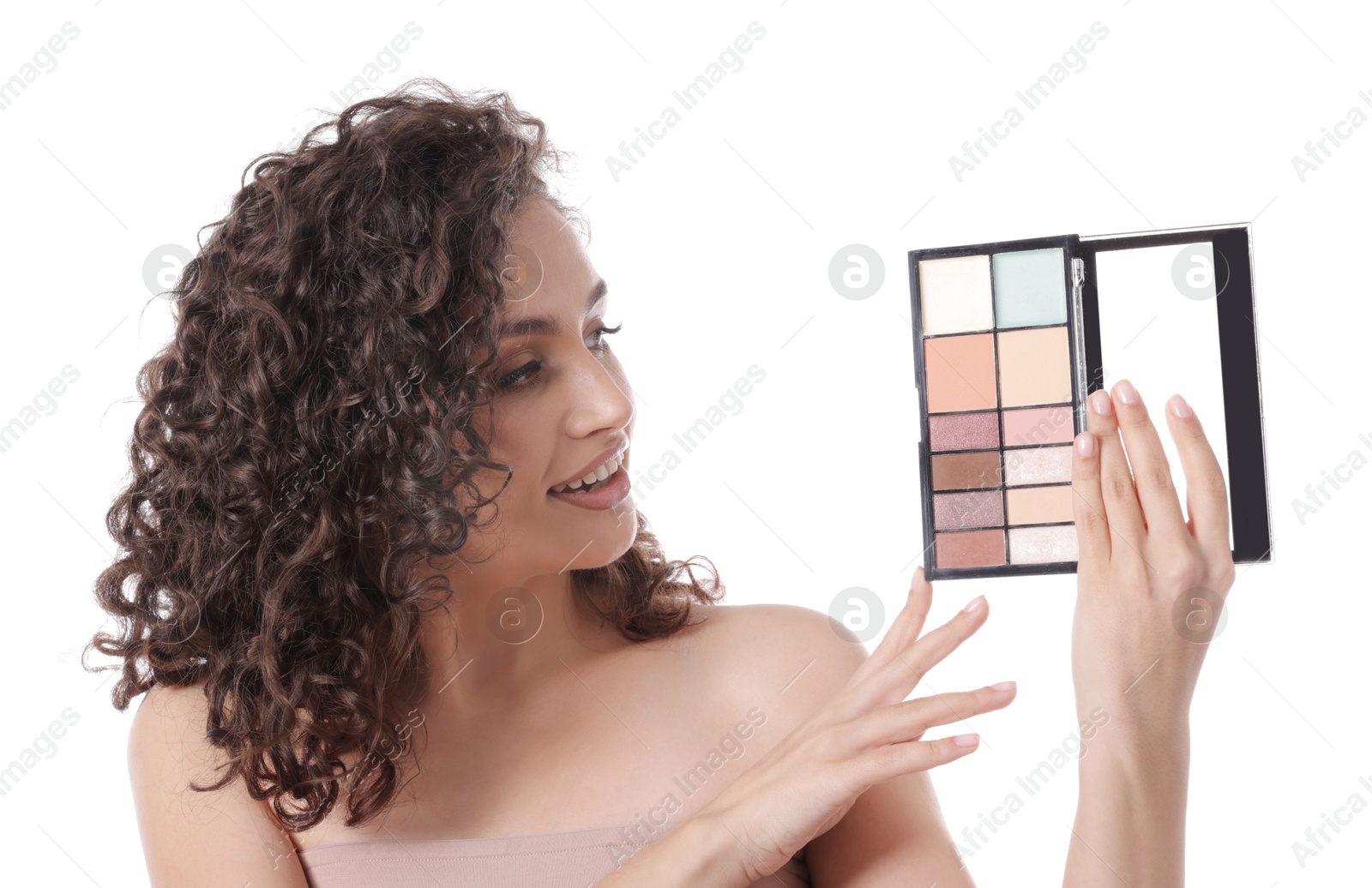 Smiling woman with eyeshadow palette on white background Photo of Smiling woman with eyeshadow palette on white background