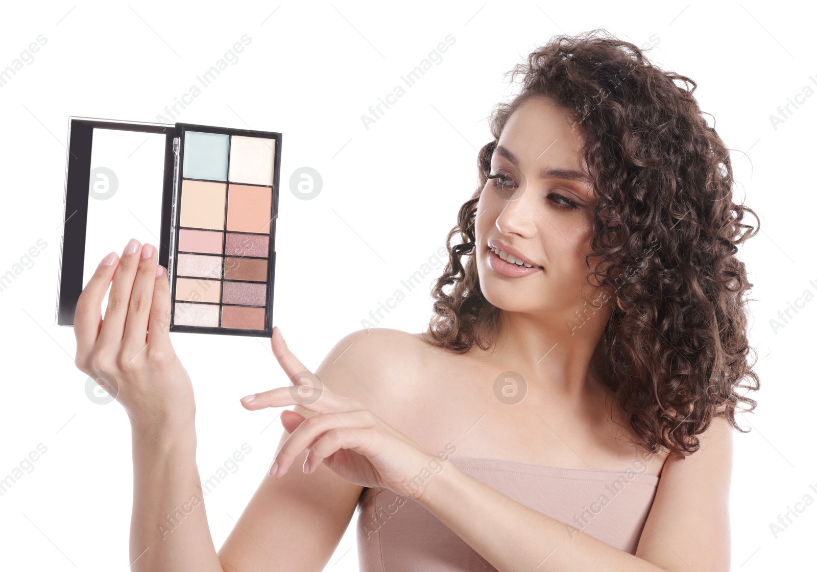Smiling woman with eyeshadow palette on white background Photo of Smiling woman with eyeshadow palette on white background