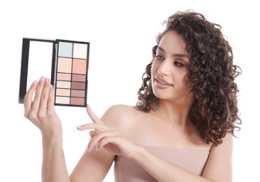 Photo of Smiling woman with eyeshadow palette on white background