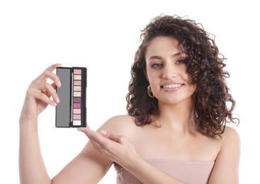 Photo of Smiling woman with eyeshadow palette on white background