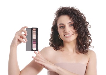 Photo of Smiling woman with eyeshadow palette on white background
