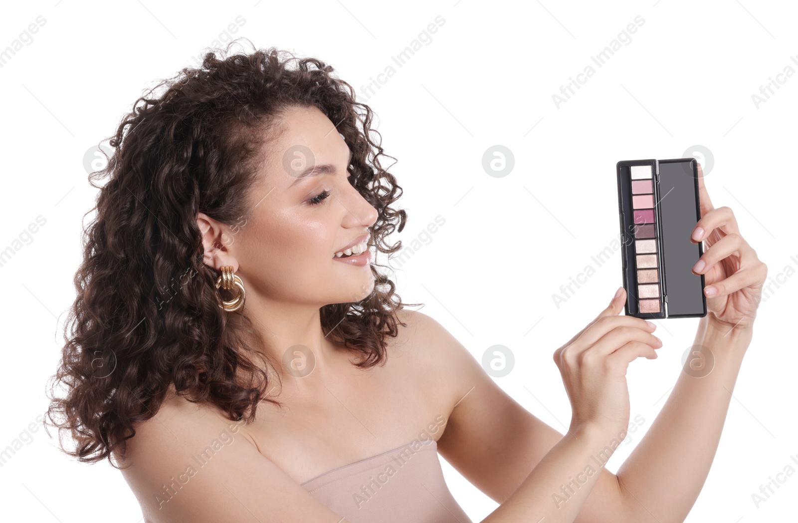 Smiling woman with eyeshadow palette on white background Photo of Smiling woman with eyeshadow palette on white background