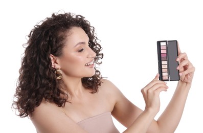 Photo of Smiling woman with eyeshadow palette on white background
