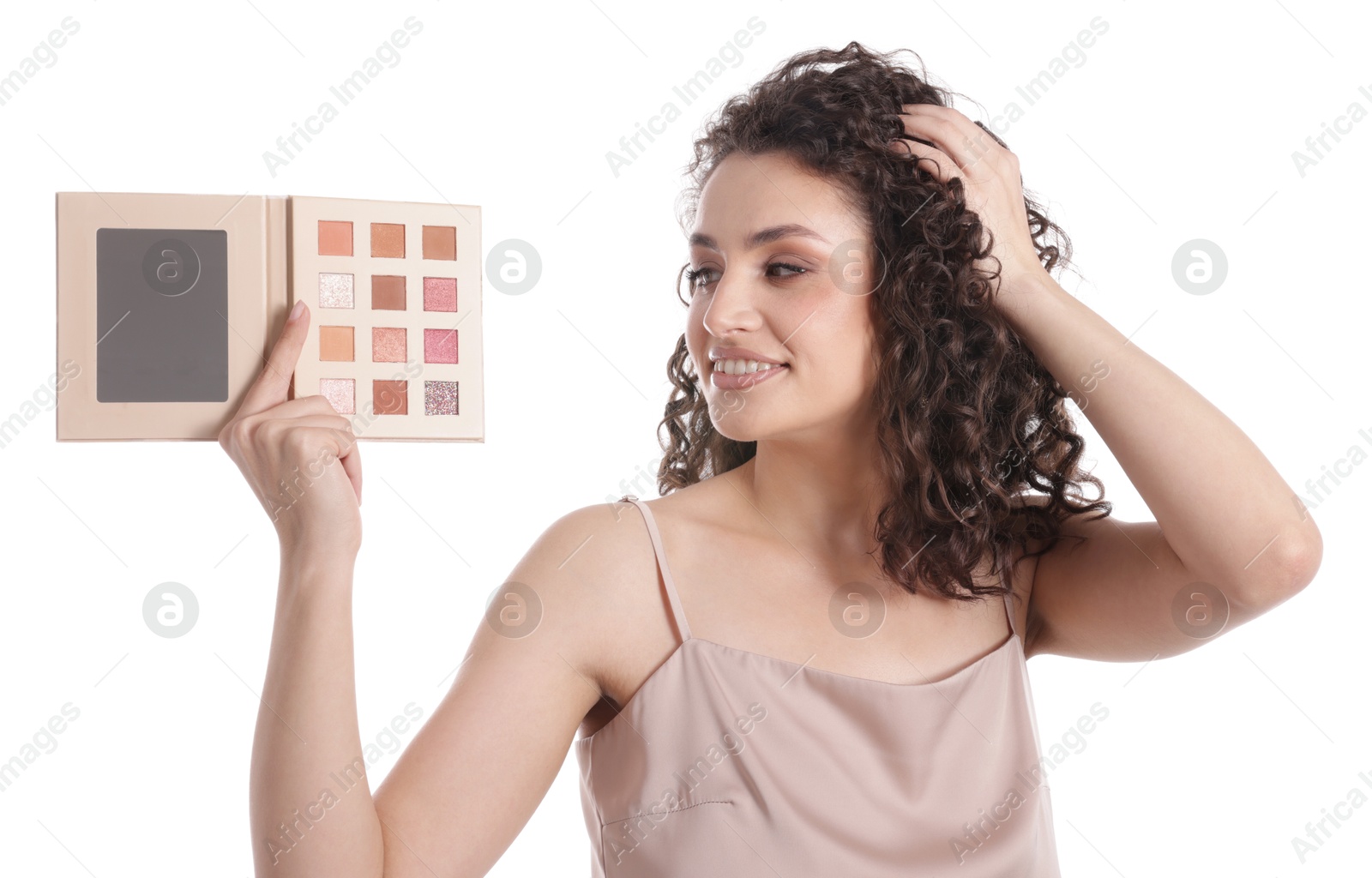 Smiling woman with eyeshadow palette on white background Photo of Smiling woman with eyeshadow palette on white background