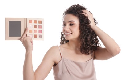 Photo of Smiling woman with eyeshadow palette on white background