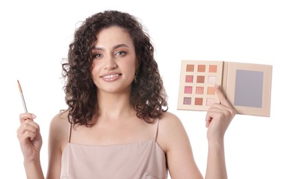 Photo of Smiling woman with eyeshadow palette and brush on white background