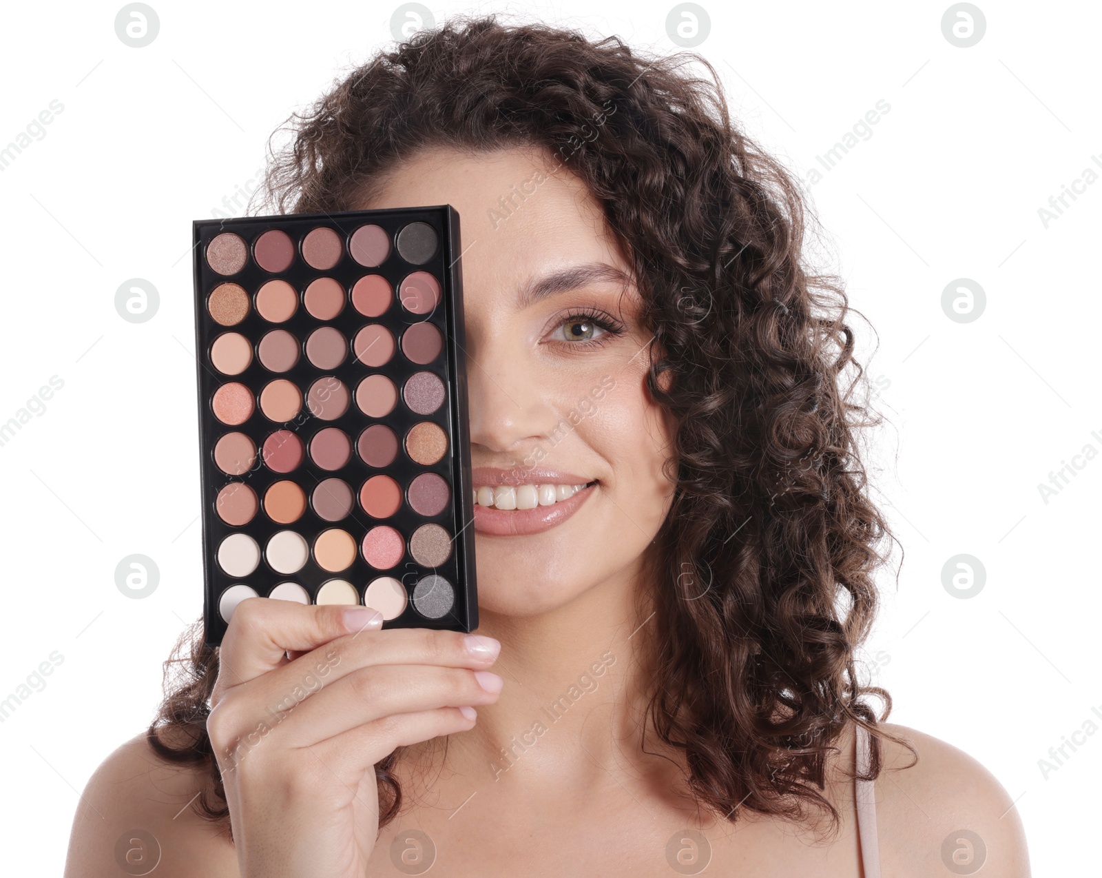 Smiling woman covering eye with eyeshadow palette on white background Photo of Smiling woman covering eye with eyeshadow palette on white background