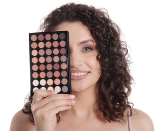 Photo of Smiling woman covering eye with eyeshadow palette on white background