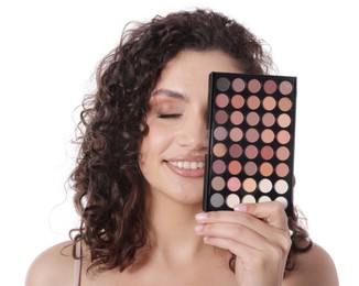 Photo of Smiling woman covering eye with eyeshadow palette on white background
