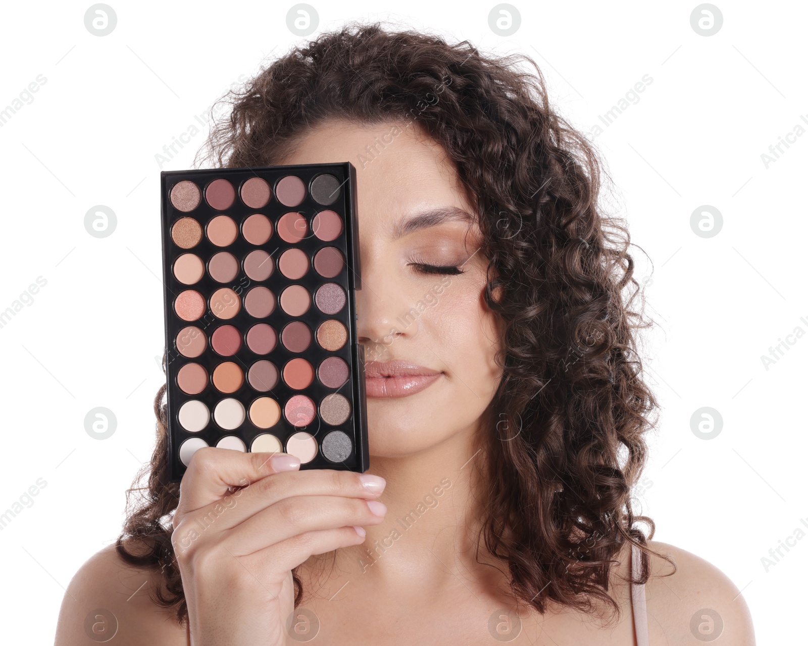 Woman covering eye with eyeshadow palette on white background Photo of Woman covering eye with eyeshadow palette on white background