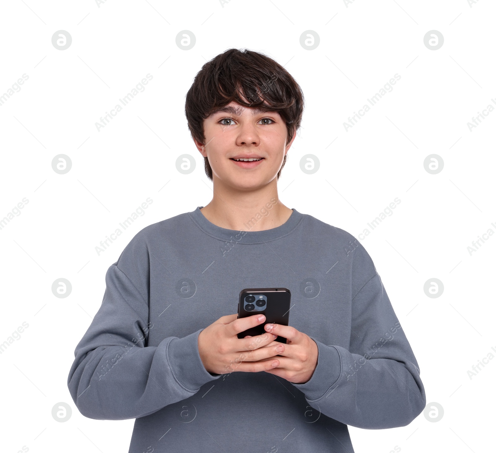Teenage boy with smartphone on white background Photo of Teenage boy with smartphone on white background